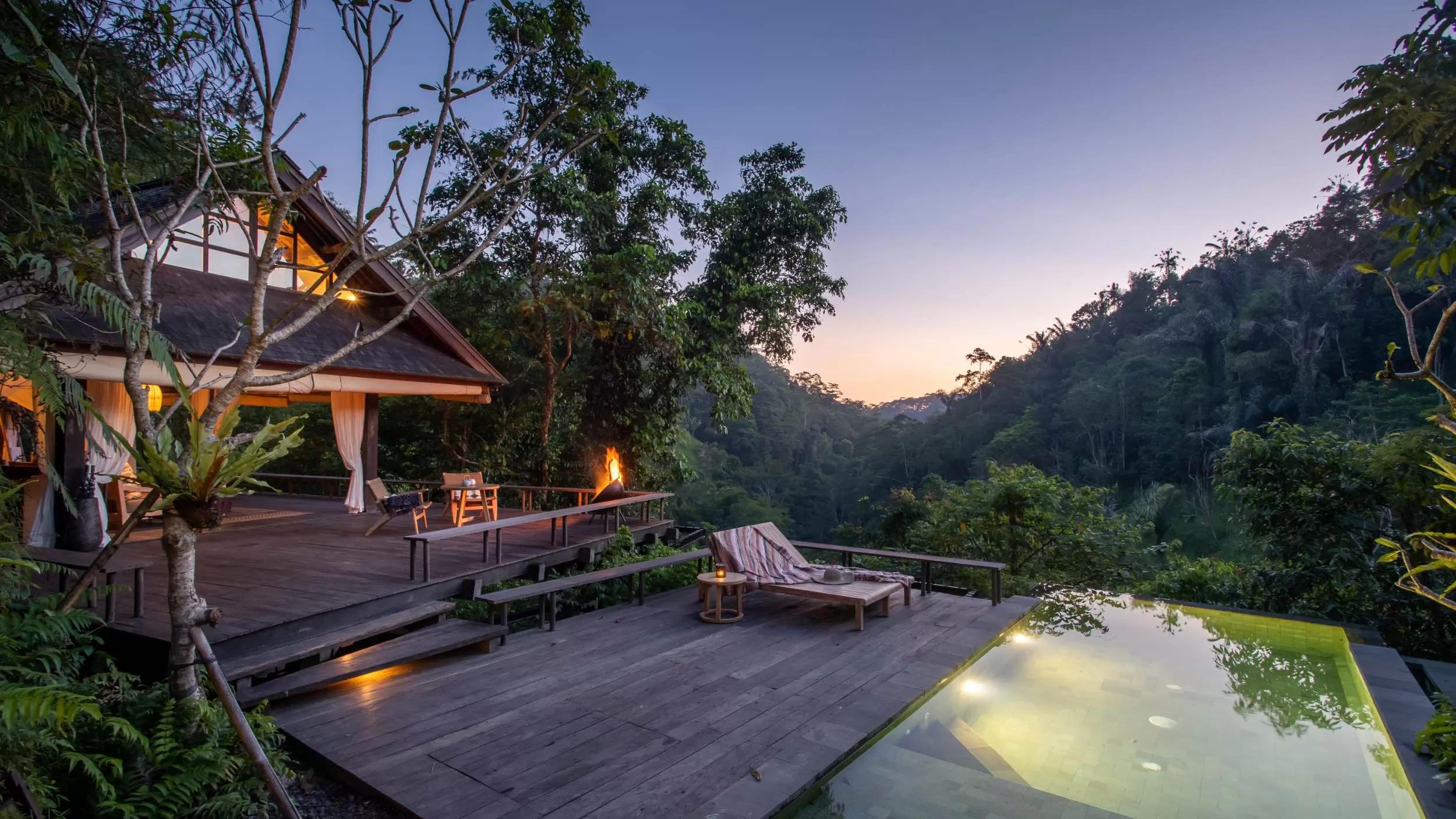 Pool reflecting sunset, Banyan Tree Escape - Buahan river valley pool bale, surrounded by lush forest.