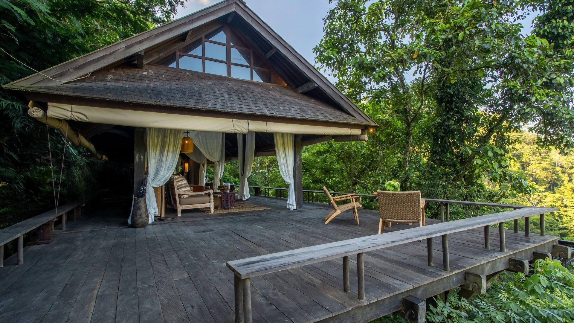 Thatched villa with open terrace amidst lush greenery at Banyan Tree Escape - Buahan.
