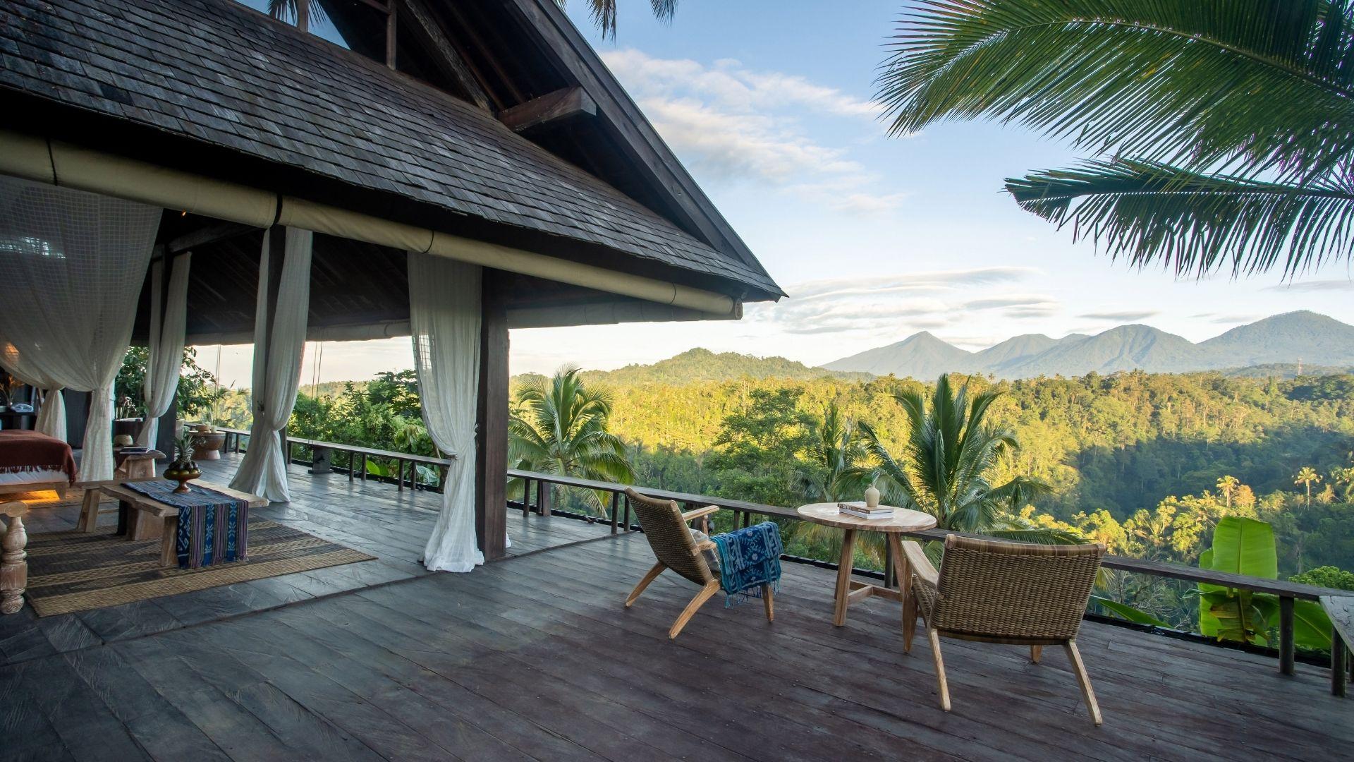 Terrace overlooks lush forest and mountains at Banyan Tree Escape - Buahan, Seven Peaks Pool Bale.