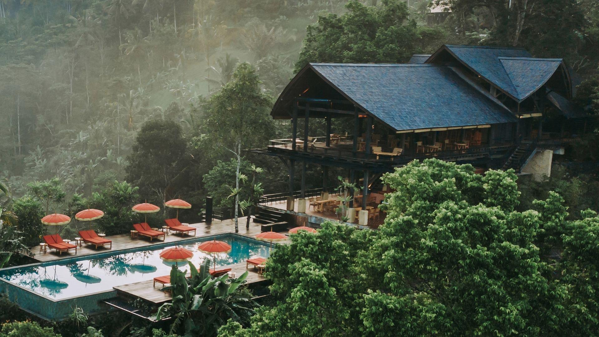 Lodge overlooks rainforest, pool with red umbrellas; Banyan Tree Escape - Buahan, Open Kitchen Restaurant.